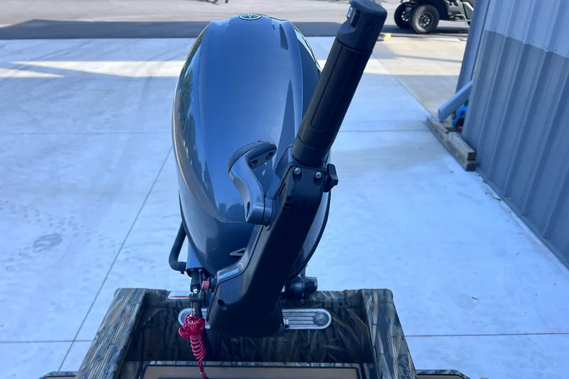 Slide: The Image of 2025 Tracker Grizzly 1650 T Prairie Wings Edition outboard motor, parked on concrete. - 18