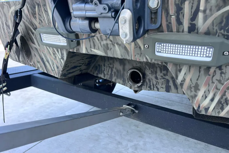 Slide: The Image of 2025 Tracker Grizzly 1650 T Prairie Wings Edition boat with camouflage design on trailer. - 23