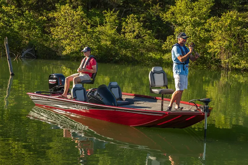 Slide: The Image of Manufacturer Provided Image: 2020 Lowe Stinger 175C fishing boat on a calm lake with two people fishing. - 15