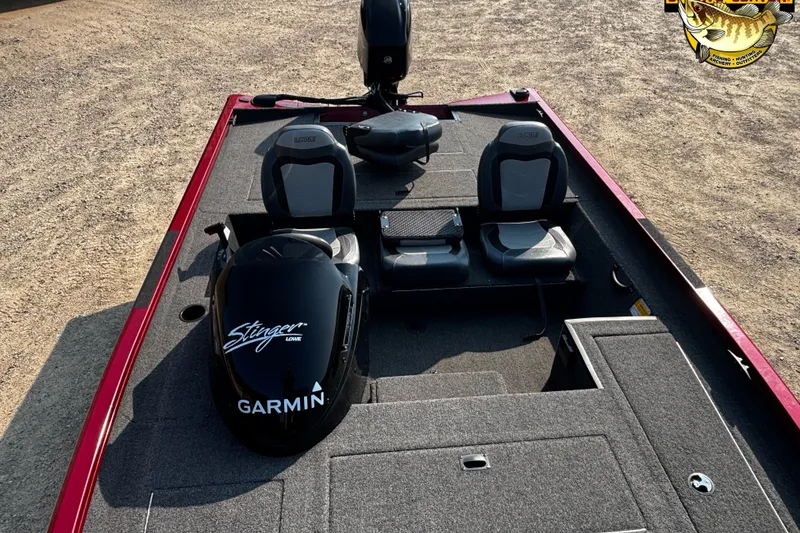 Slide: The Image of 2020 Lowe Stinger 175C boat interior with Garmin motor, gray seating, and red trim. - 4