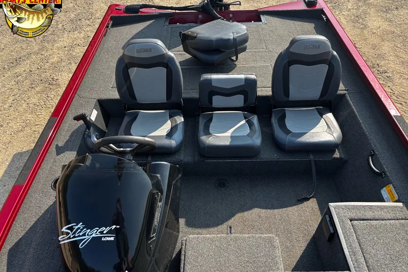 Slide: The Image of 2020 Lowe Stinger 175C boat interior with three gray seats and steering console. - 5
