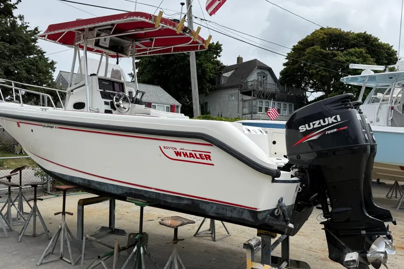 Slide: The Image of 1998 Boston Whaler 23 Outrage boat with Suzuki outboard motor on stands. - 3
