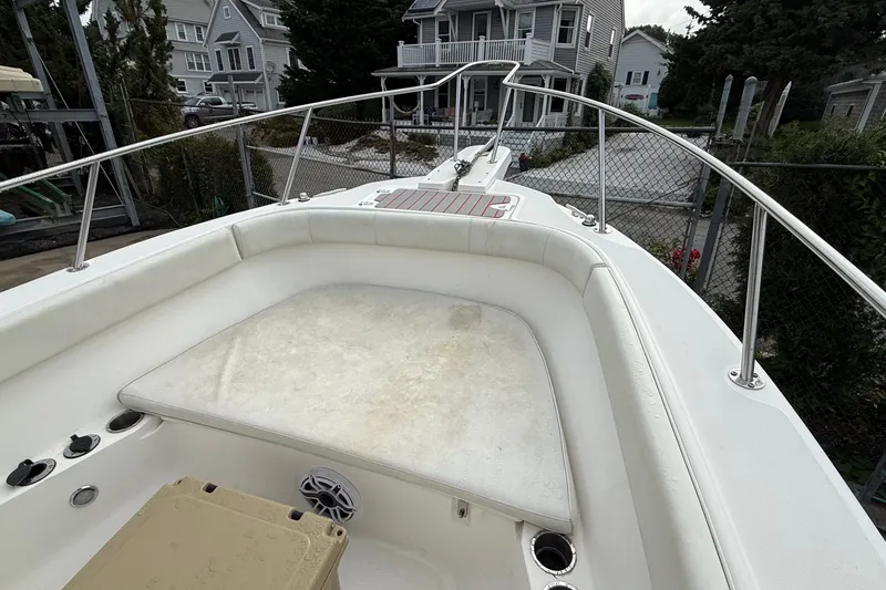 Slide: The Image of 1998 Boston Whaler 23 Outrage boat interior with cushioned seating and railing. - 8