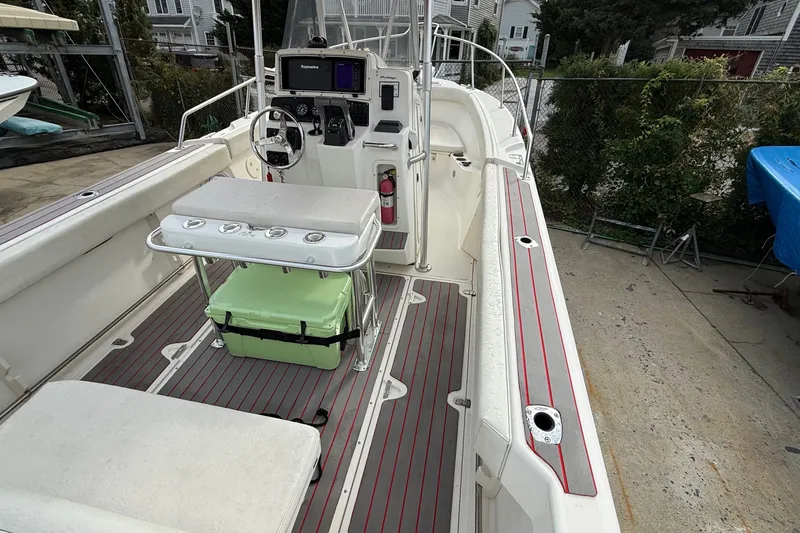 Slide: The Image of 1998 Boston Whaler 23 Outrage boat interior with seating and steering console. - 5