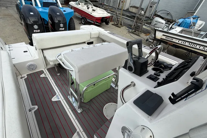 Slide: The Image of 1998 Boston Whaler 23 Outrage boat interior with seating and control panel. - 6