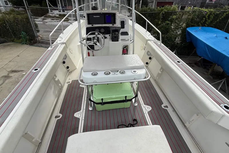 Slide: The Image of 1998 Boston Whaler 23 Outrage boat interior with steering console and seating. - 9