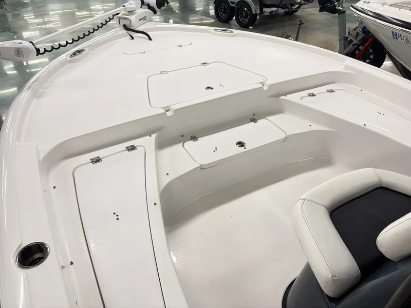 Slide: The Image of The image shows the deck of a 2021 Tidewater 2210 Carolina Bay boat with storage and seating area. - 10