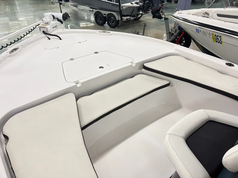 Slide: The Image of The image shows the deck of a 2021 Tidewater 2210 Carolina Bay boat with white cushions. - 15