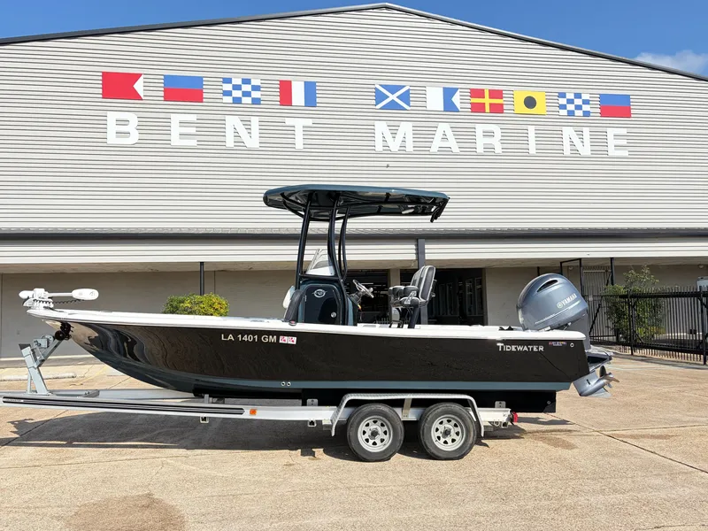 The Image of A black 2021 Tidewater 2210 Carolina Bay boat on a trailer in front of a building. - 1