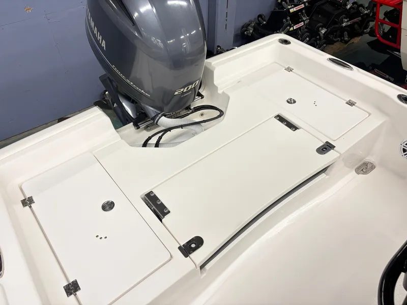 Slide: The Image of The image shows the stern of a Tidewater 2210 Carolina Bay boat with a Yamaha 200 engine. - 6