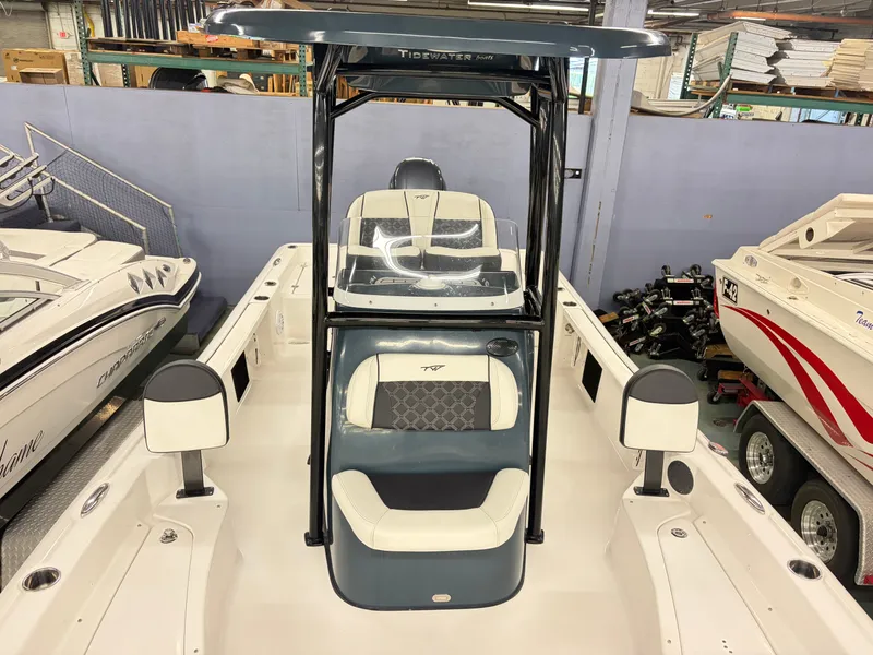 Slide: The Image of The image shows a 2021 Tidewater 2210 Carolina Bay boat in a showroom. - 13