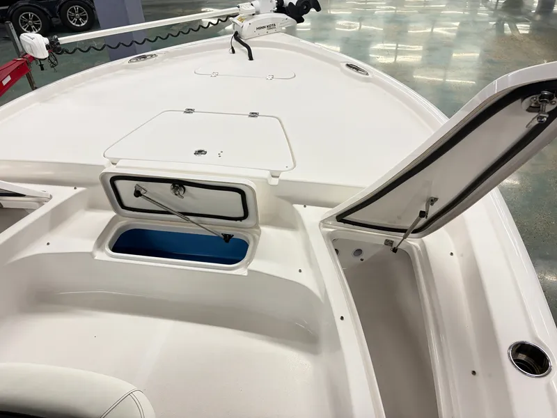 Slide: The Image of The image shows the deck of a 2021 Tidewater 2210 Carolina Bay boat with storage compartments. - 11