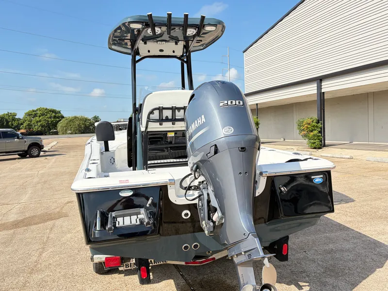 Slide: The Image of A 2021 Tidewater 2210 Carolina Bay boat with a Yamaha 200 outboard motor, parked on a concrete lot. - 5