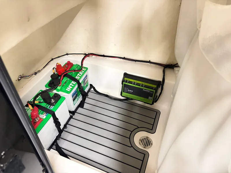 Slide: The Image of Battery compartment with two car batteries and a charger in a boat. - 14