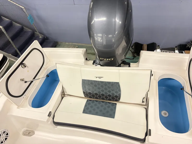 Slide: The Image of The image shows the stern of a 2021 Tidewater 2210 Carolina Bay boat with an outboard motor. - 7