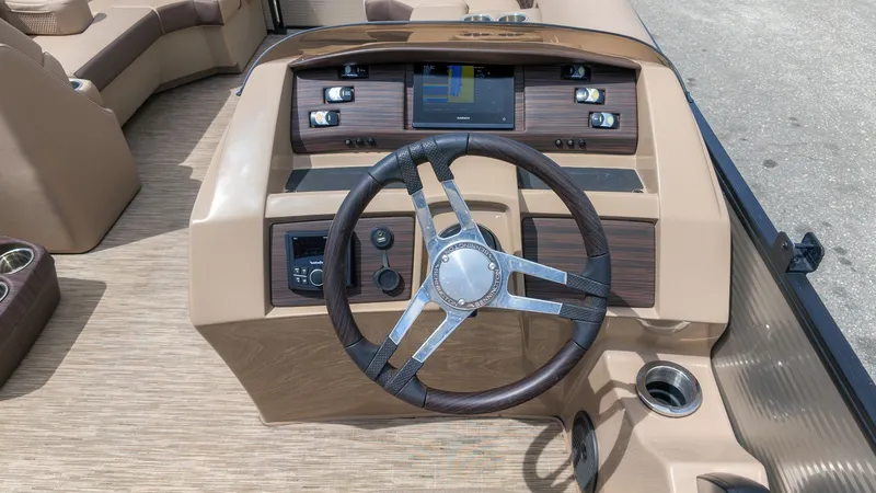Slide: The Image of The image shows the cockpit of a 2022 Bennington 22 LSB with a sleek steering wheel. - 16