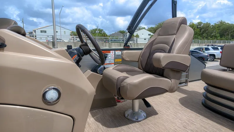 Slide: The Image of The image shows the driver's seat of a 2022 Bennington 22 LSB with beige upholstery. - 13