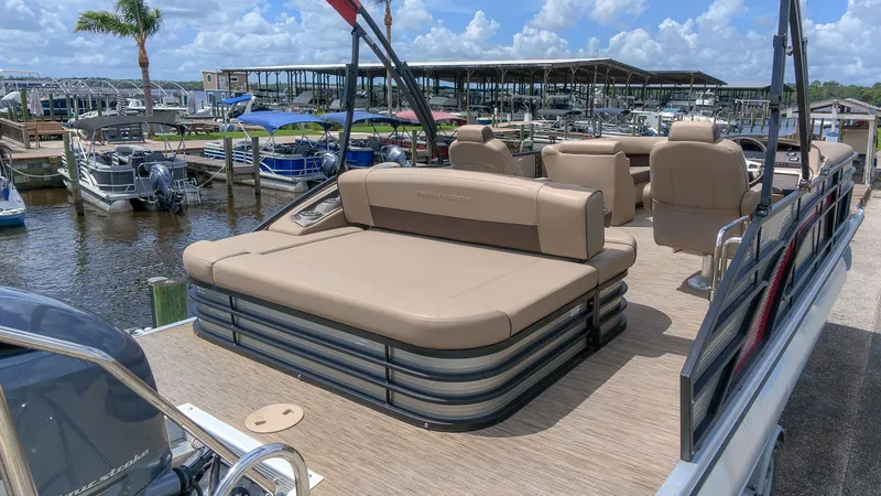 Slide: The Image of 2022 Bennington 22 LSB with spacious deck and comfortable seating at the marina. - 4