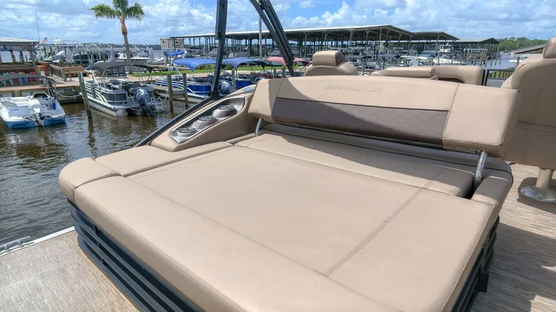 Slide: The Image of The image shows the sun deck of a 2022 Bennington 22 LSB at a marina. - 4