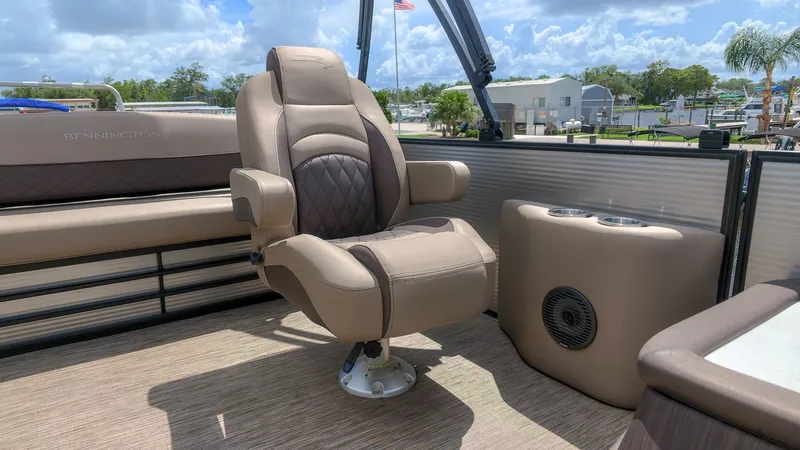 Slide: The Image of Luxurious captain's chair on a Bennington 22 LSB pontoon boat, surrounded by comfortable seating and a speaker. - 6