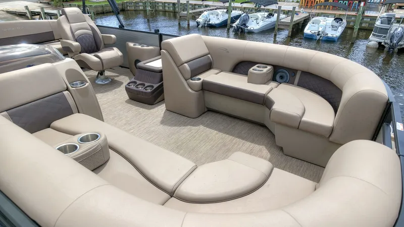 Slide: The Image of The image shows the luxurious interior of a 2022 Bennington 22 LSB pontoon boat with beige seating. - 8