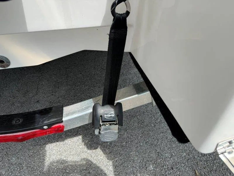 Slide: The Image of Close-up of a boat trailer with a safety strap attached to a Robalo 246 Cayman. - 27