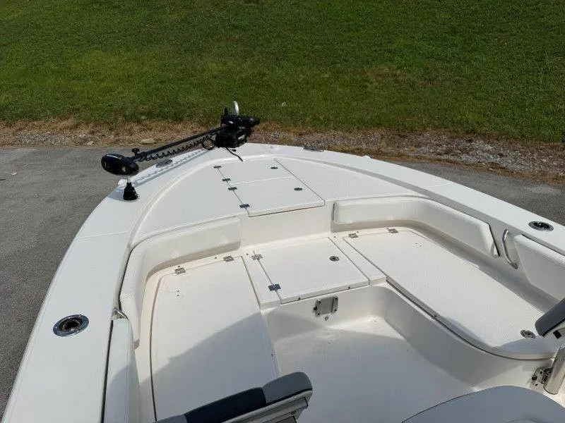 Slide: The Image of The image shows the deck of a 2023 Robalo 246 Cayman boat with storage and seating. - 46