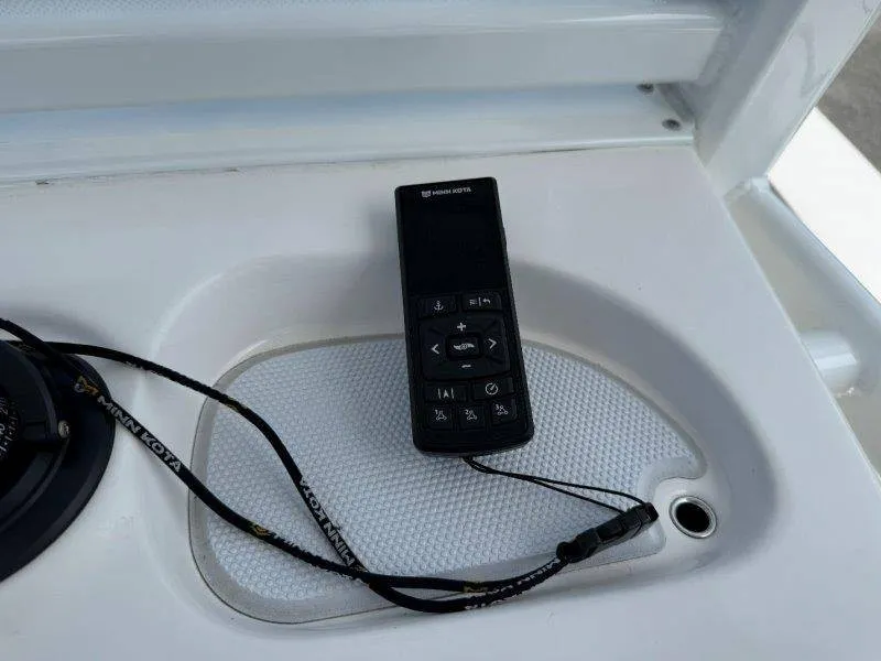 Slide: The Image of Remote control on a boat with a white dashboard. - 48