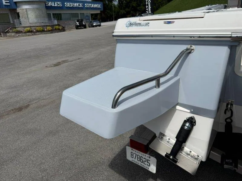 Slide: The Image of The 2023 Robalo 246 Cayman features a swim platform with a handrail at the stern. - 22
