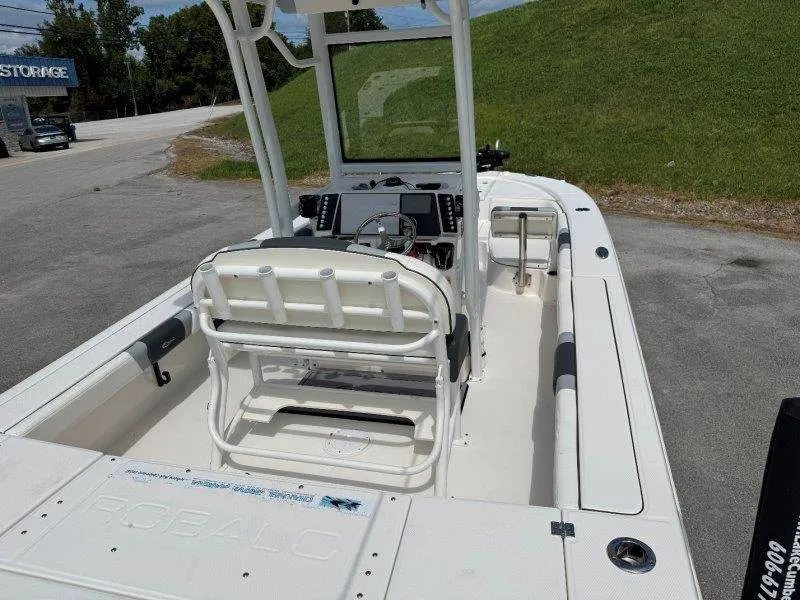 Slide: The Image of The image shows a 2023 Robalo 246 Cayman boat with a spacious cockpit and helm station. - 29