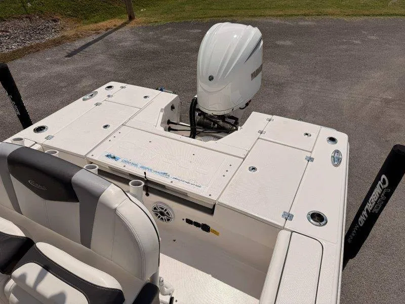 Slide: The Image of The image shows the stern of a 2023 Robalo 246 Cayman boat with an outboard motor. - 13