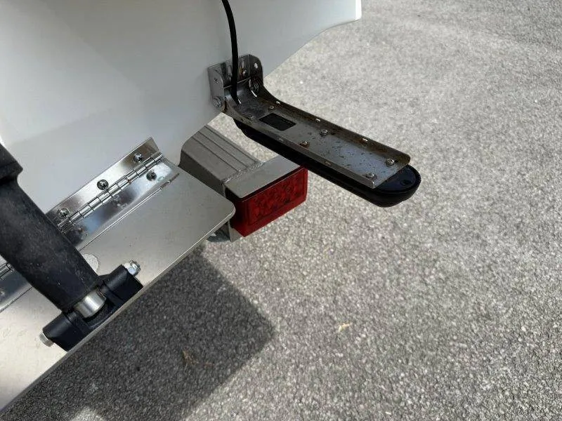Slide: The Image of Close-up of a boat's stern with a metal trim tab and a red taillight. - 30