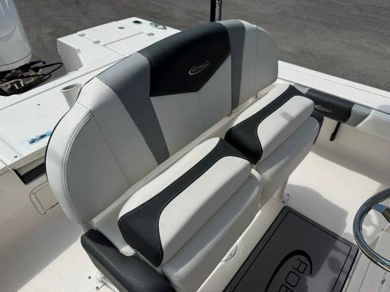 Slide: The Image of The 2023 Robalo 246 Cayman features a stylish, cushioned bench seat with a two-tone design. - 45
