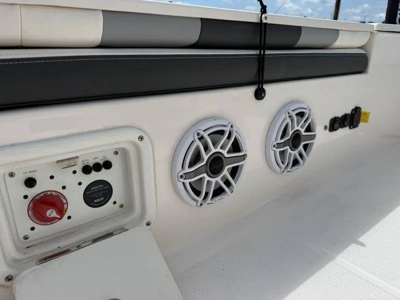 Slide: The Image of The image shows the cockpit of a 2023 Robalo 246 Cayman with speakers and controls. - 38