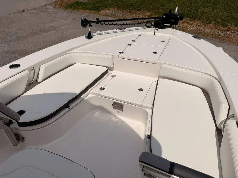 Slide: The Image of The image shows the deck of a 2023 Robalo 246 Cayman with seating and storage. - 15