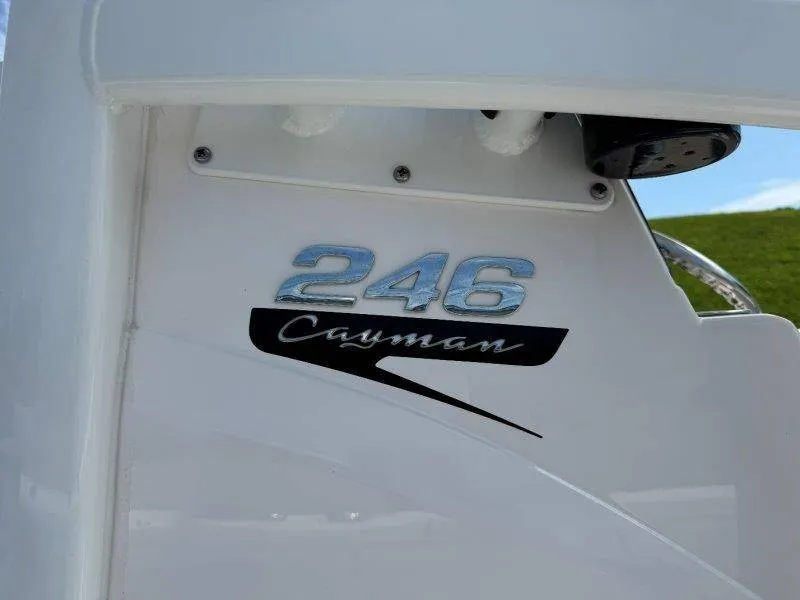 Slide: The Image of Close-up of the Robalo 246 Cayman logo on a white boat. - 25