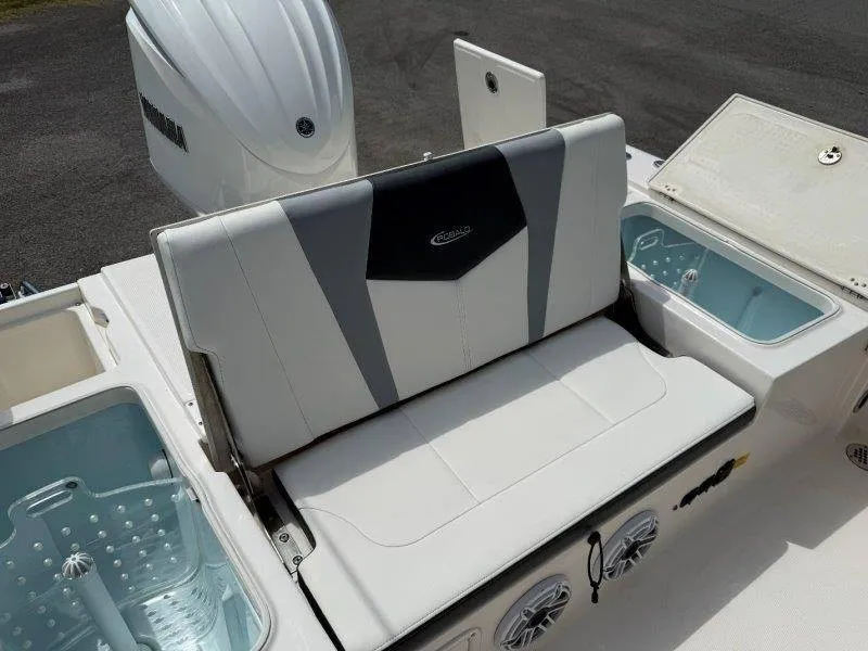 Slide: The Image of The 2023 Robalo 246 Cayman features a cushioned bench seat with integrated storage and a Yamaha engine. - 37