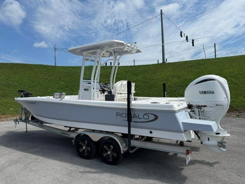 Slide: The Image of A 2023 Robalo 246 Cayman boat on a trailer with Yamaha engine, ready for adventure. - 2