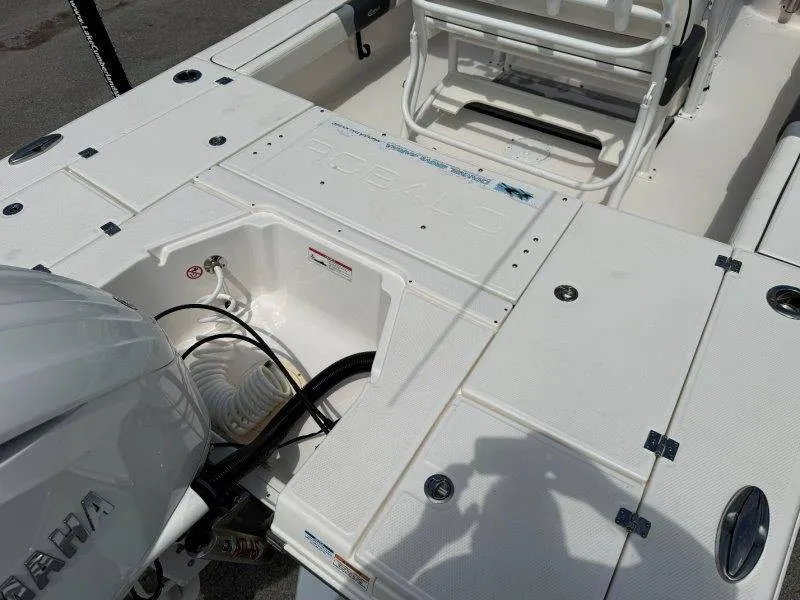 Slide: The Image of The image shows the deck of a 2023 Robalo 246 Cayman boat with an engine. - 26