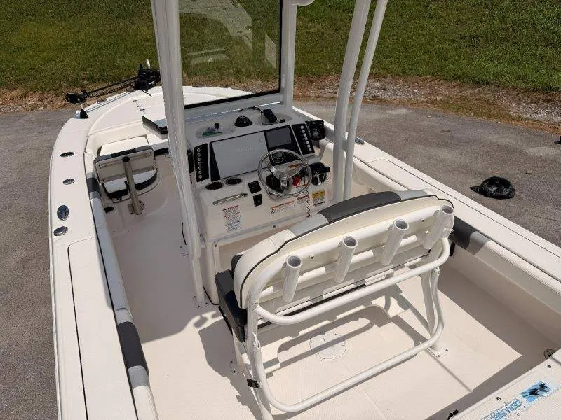 Slide: The Image of The image shows the cockpit of a 2023 Robalo 246 Cayman with a helm and seating. - 31