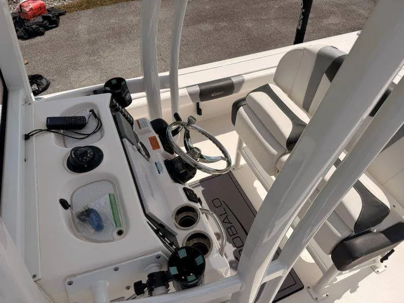 Slide: The Image of The image shows the cockpit of a 2023 Robalo 246 Cayman with a helm console and seating. - 11