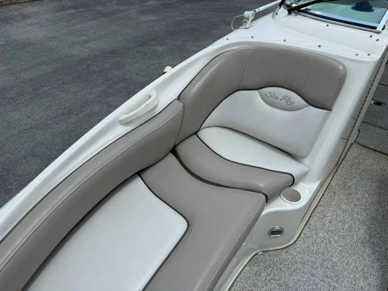 Slide: The Image of The image shows the cushioned seating of a 2003 Sea Ray 240 Sundeck. - 45
