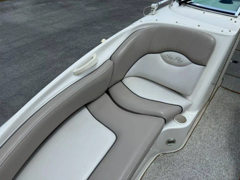 Slide: The Image of The image shows the cushioned seating of a 2003 Sea Ray 240 Sundeck. - 44