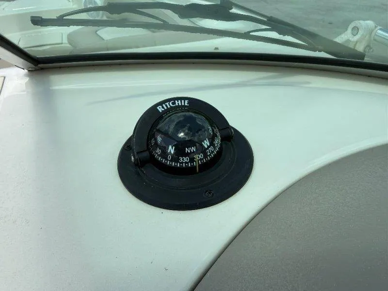 Slide: The Image of A Ritchie compass is mounted on the dashboard of a 2003 Sea Ray 240 Sundeck. - 21