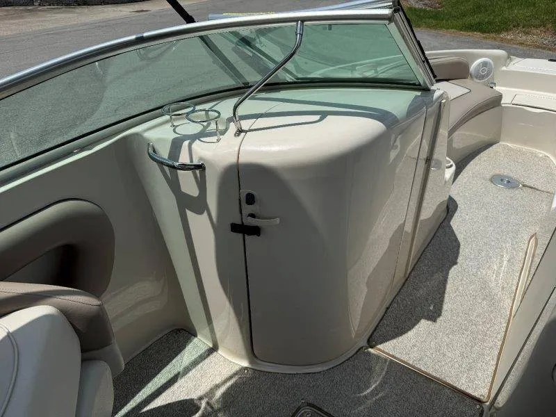 Slide: The Image of The image shows the cockpit of a 2003 Sea Ray 240 Sundeck with beige seating. - 28
