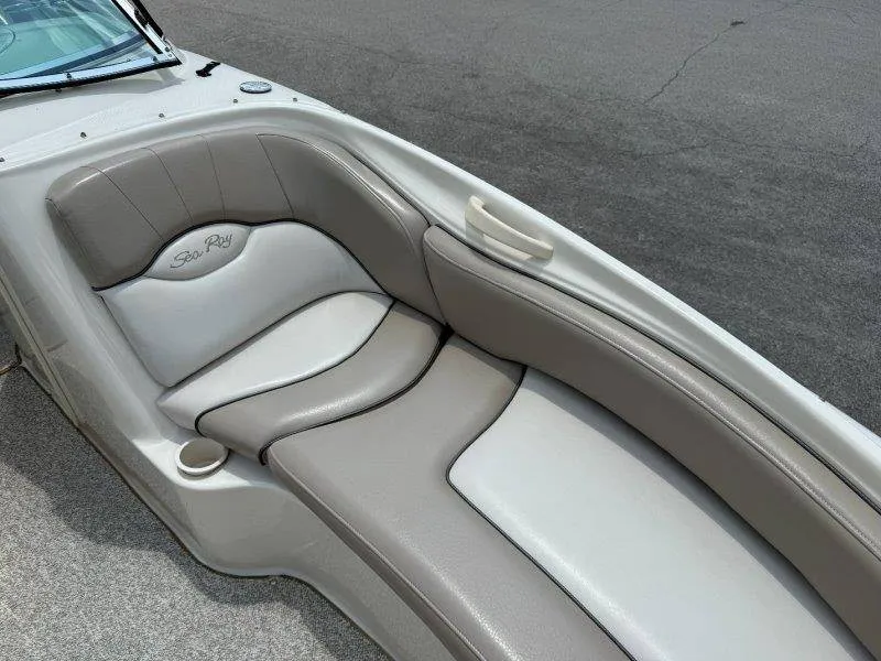 Slide: The Image of The image shows a gray and white seating area on a Sea Ray 240 Sundeck boat. - 48