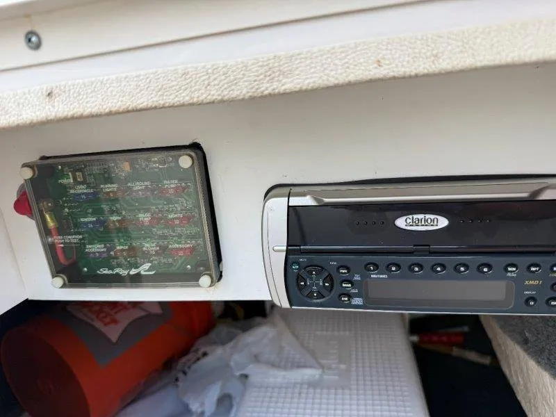 Slide: The Image of A Clarion audio system and a fuse box are installed in a 2003 Sea Ray 240 Sundeck. - 41