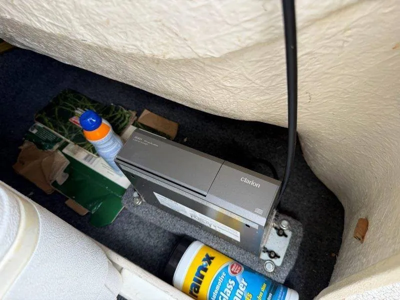 Slide: The Image of A Clarion audio device is installed in a boat, surrounded by cleaning supplies and cardboard. - 32