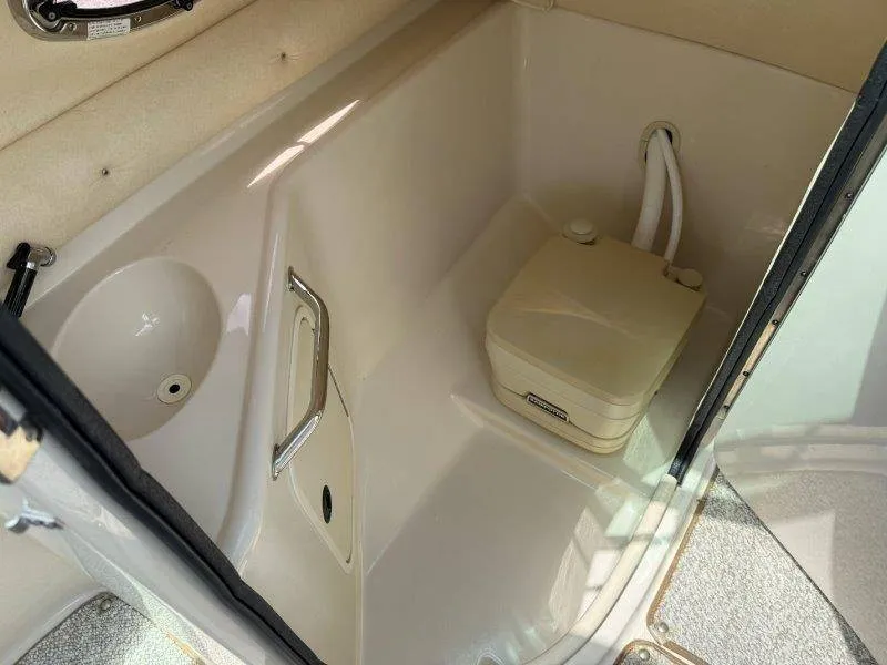 Slide: The Image of The image shows a compact boat toilet with a portable toilet and a sink. - 36