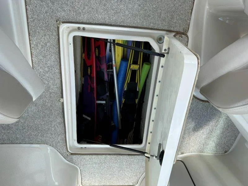 Slide: The Image of An open storage compartment in a boat's floor containing watersports equipment. - 22